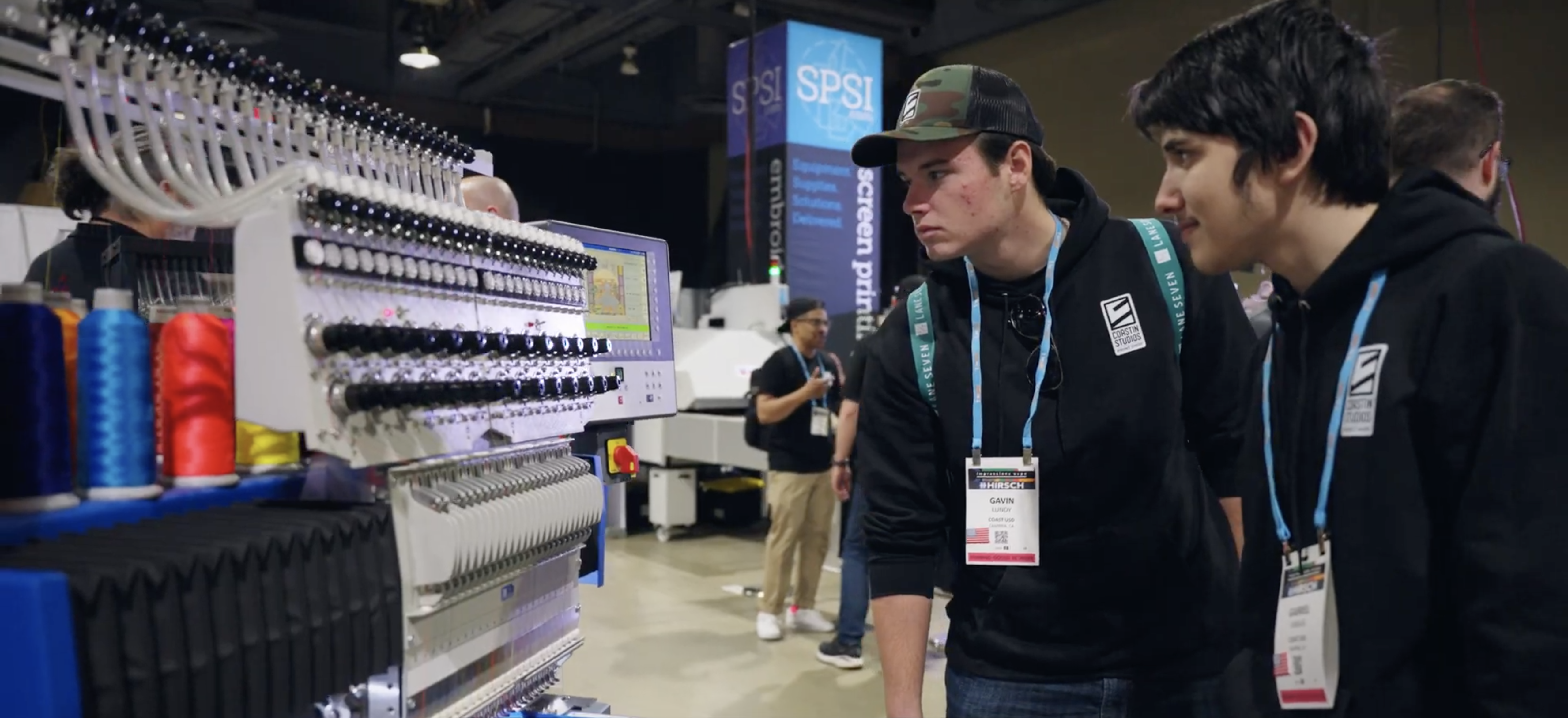 Two Coastin' Studios student workers examine new technologies at a recent industry conference.